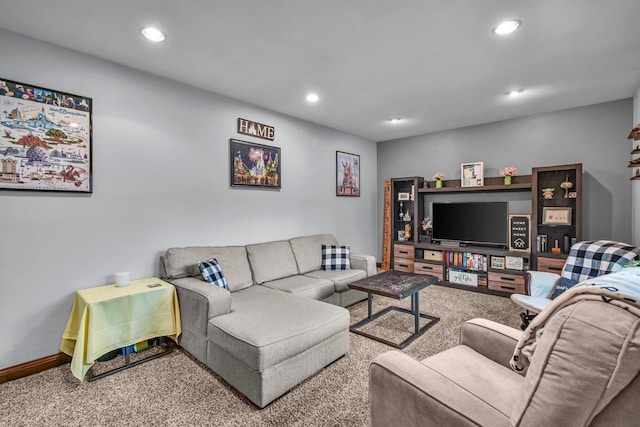 carpeted living area with recessed lighting and baseboards