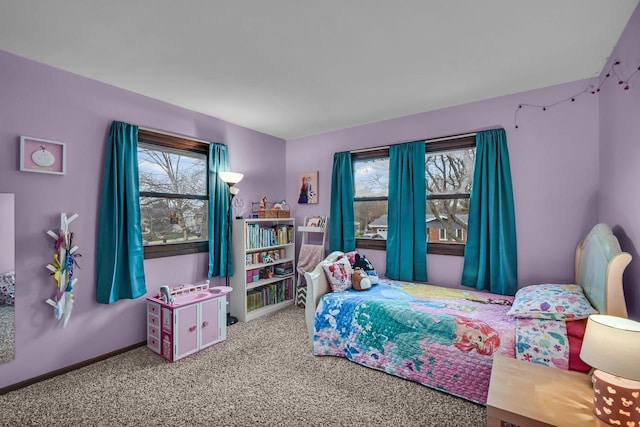 carpeted bedroom with baseboards and multiple windows