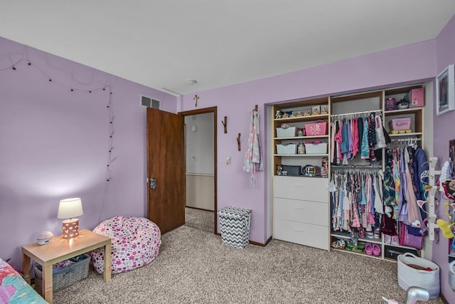 bedroom with carpet flooring, visible vents, and a closet