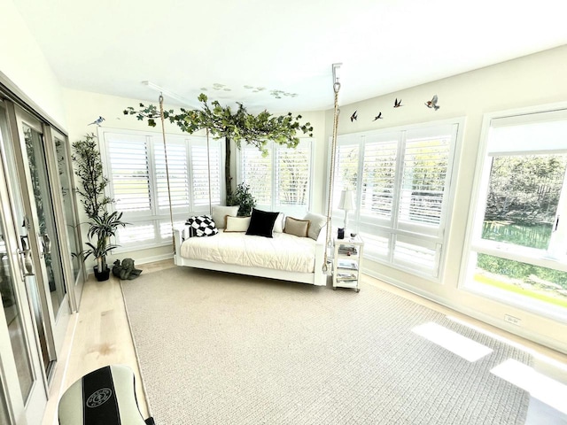 sunroom with a healthy amount of sunlight and baseboards