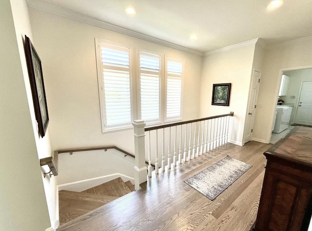 staircase featuring ornamental molding, washer / dryer, wood finished floors, baseboards, and recessed lighting