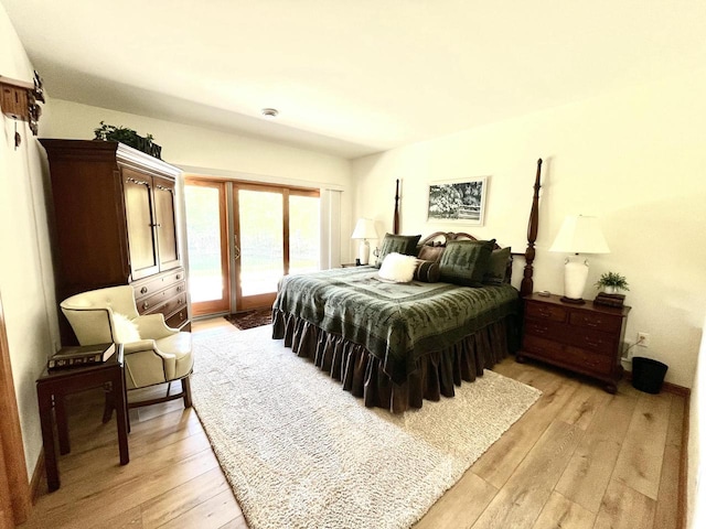 bedroom with access to outside and light wood-style flooring