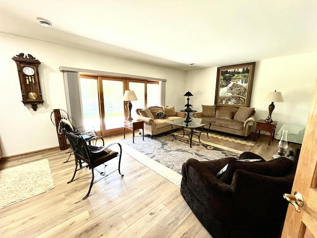 living area with baseboards and light wood-type flooring