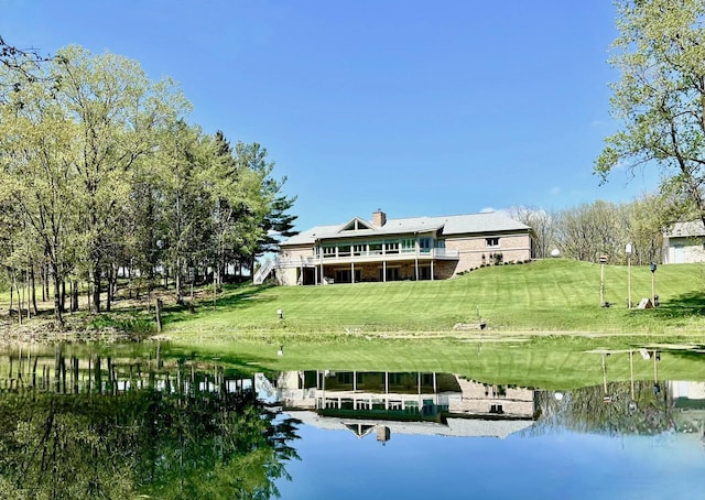 surrounding community with a lawn, a boat dock, and a water view