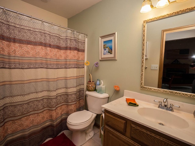 full bathroom featuring vanity, tile patterned floors, and toilet