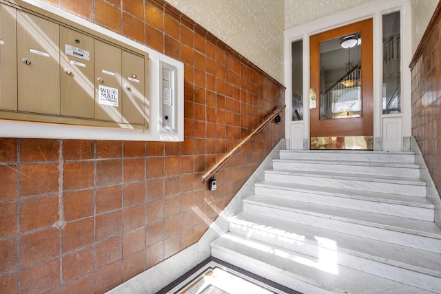 stairs featuring tile walls
