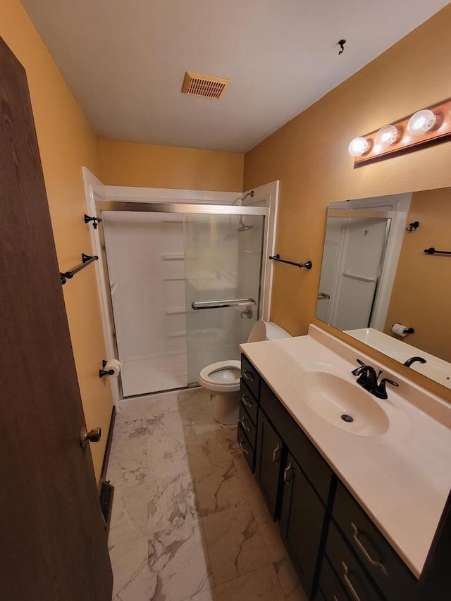 bathroom with visible vents, a shower stall, vanity, toilet, and marble finish floor