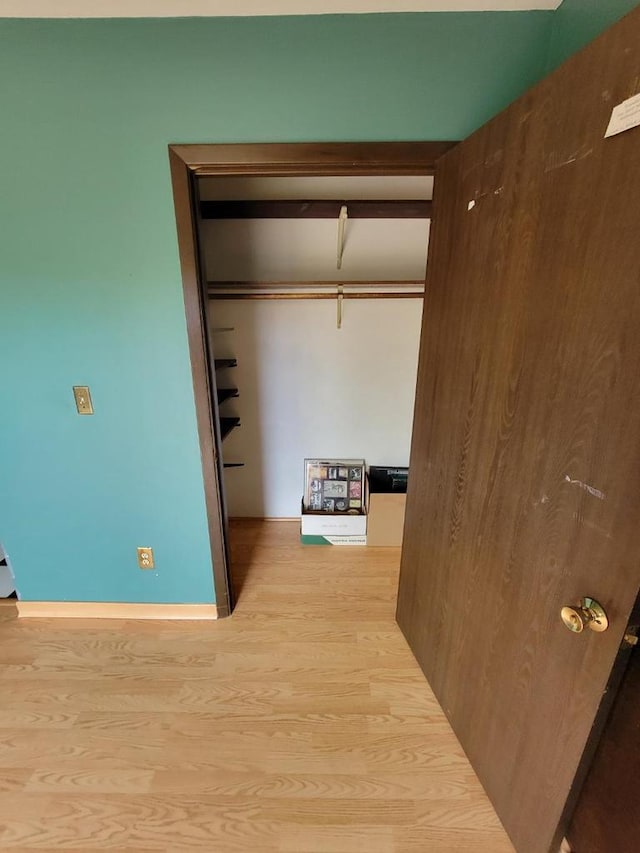 hall with wood finished floors