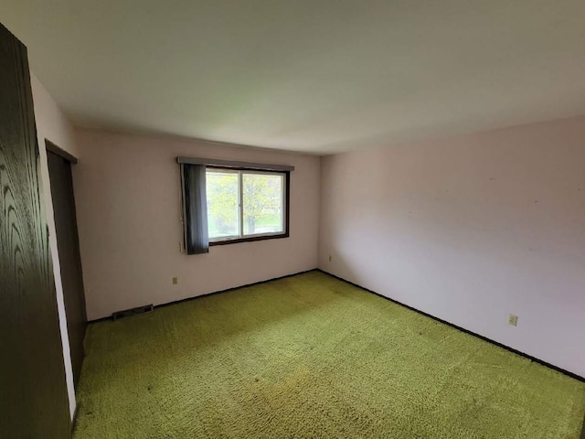 spare room with light colored carpet and visible vents