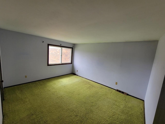unfurnished room featuring baseboards and light carpet