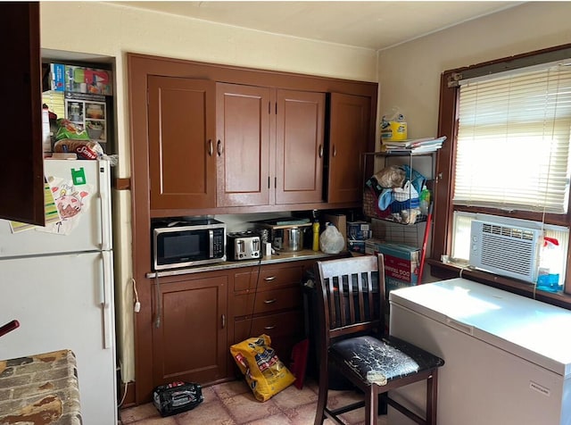 4566 N 28th St, Milwaukee, WI 53209 - kitchen featuring fridge, light countertops, freestanding refrigerator, stainless steel microwave, and cooling unit