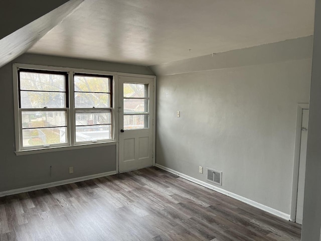 4566 N 28th St, Milwaukee, WI 53209 - interior space featuring baseboards, visible vents, wood finished floors, and vaulted ceiling