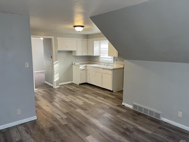 4566 N 28th St, Milwaukee, WI 53209 - kitchen featuring visible vents, a sink, baseboards, and dark wood finished floors
