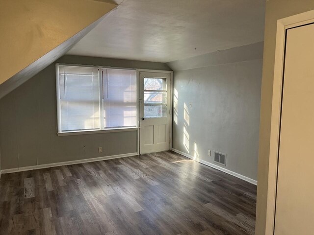 4566 N 28th St, Milwaukee, WI 53209 - additional living space featuring visible vents, baseboards, lofted ceiling, and wood finished floors