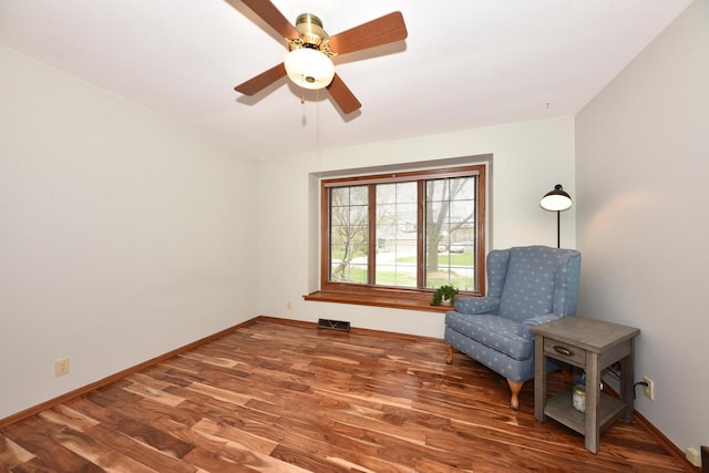 unfurnished room with baseboards, ceiling fan, visible vents, and wood finished floors
