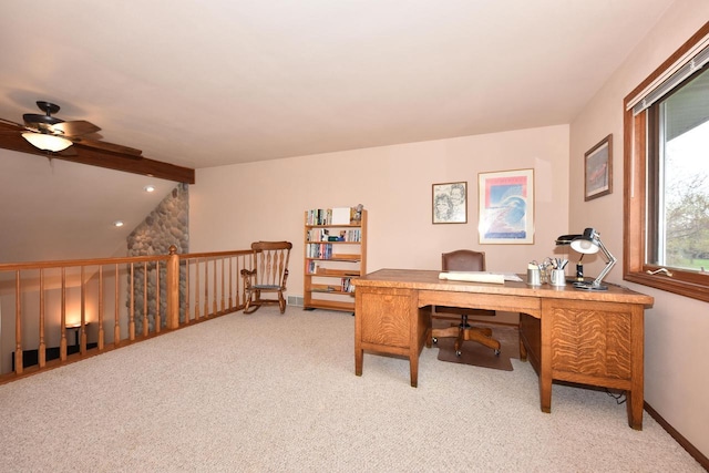 office featuring baseboards, a ceiling fan, lofted ceiling with beams, and light carpet