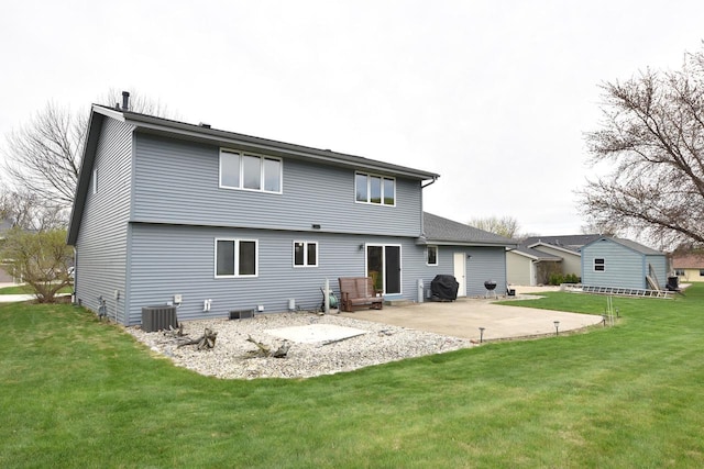 back of property with central air condition unit, a yard, and a patio area