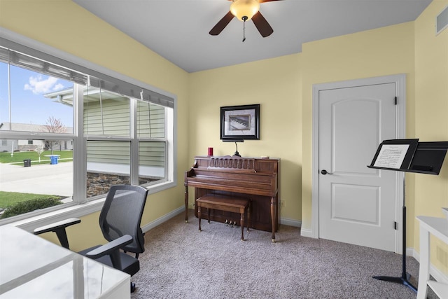 carpeted office space with visible vents, a ceiling fan, and baseboards