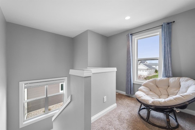 living area featuring baseboards, recessed lighting, carpet floors, and an upstairs landing