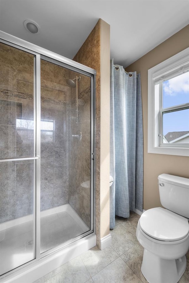 full bath featuring tile patterned flooring, baseboards, toilet, and a shower stall