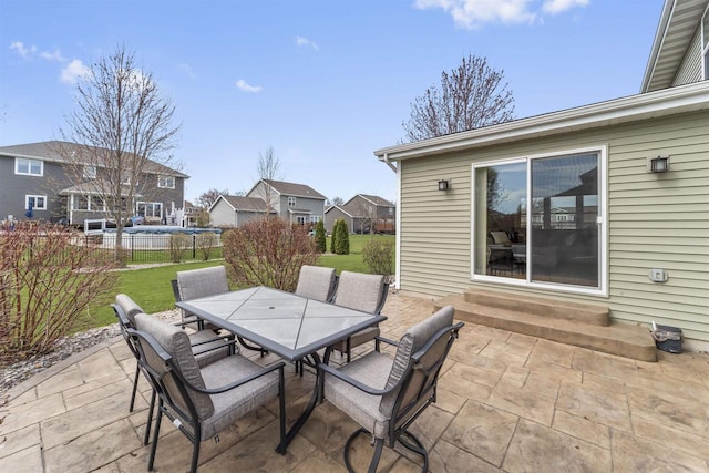 view of patio / terrace with entry steps, fence, and outdoor dining area