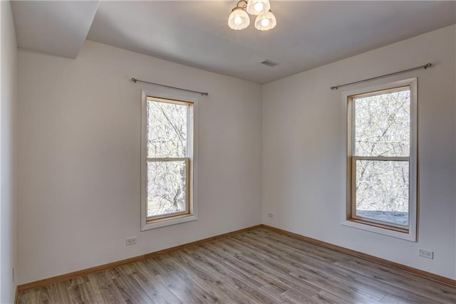 603 Dodge St, Eau Claire, WI 54701 - empty room with baseboards, wood finished floors, and visible vents