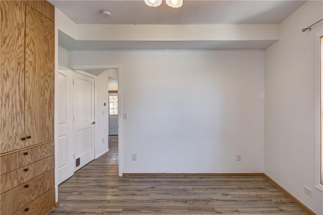 603 Dodge St, Eau Claire, WI 54701 - empty room featuring baseboards, visible vents, and wood finished floors