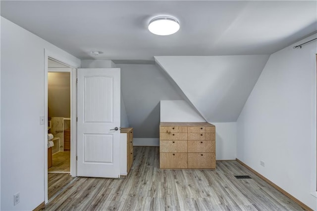 603 Dodge St, Eau Claire, WI 54701 - additional living space featuring light wood-style floors, vaulted ceiling, and visible vents