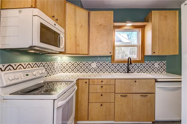 603 Dodge St, Eau Claire, WI 54701 - kitchen featuring a sink, light countertops, tasteful backsplash, and white appliances
