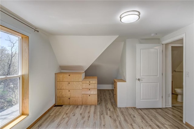 603 Dodge St, Eau Claire, WI 54701 - bonus room featuring light wood-style floors, baseboards, and vaulted ceiling