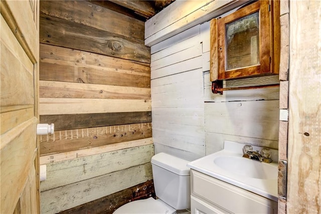 603 Dodge St, Eau Claire, WI 54701 - half bath featuring wooden walls, toilet, and vanity