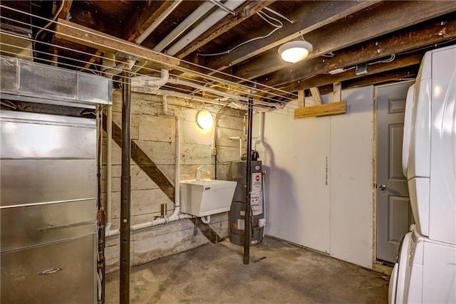 603 Dodge St, Eau Claire, WI 54701 - unfinished basement with water heater, stacked washer / dryer, and a sink