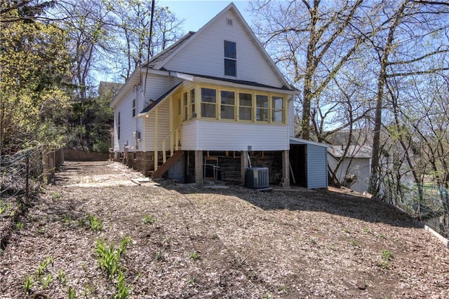 603 Dodge St, Eau Claire, WI 54701 - back of house with stairway, central AC, and fence