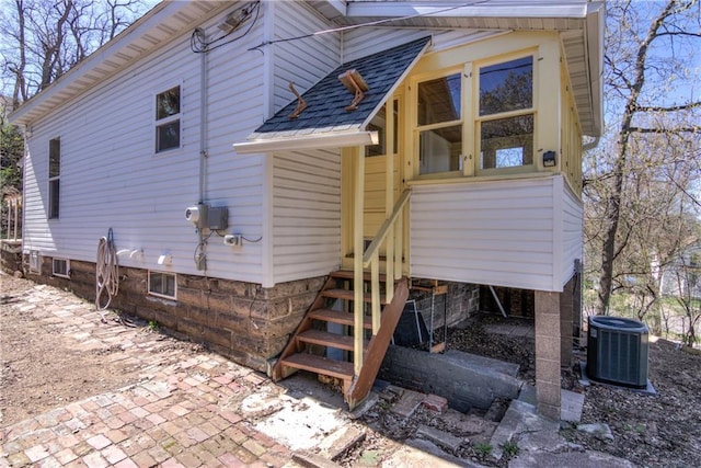 603 Dodge St, Eau Claire, WI 54701 - view of property exterior featuring central air condition unit and a shingled roof
