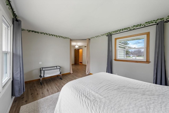 bedroom featuring baseboards and wood finished floors