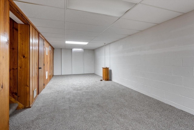 finished basement featuring carpet floors and a paneled ceiling