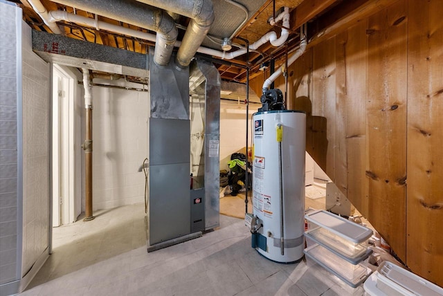 utility room with heating unit and gas water heater