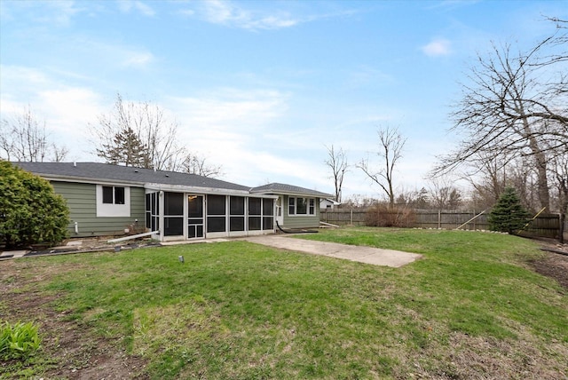back of house featuring a yard, a patio, a fenced backyard, and a sunroom