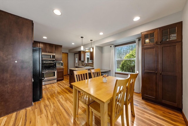 dining area with recessed lighting and light wood-style flooring
