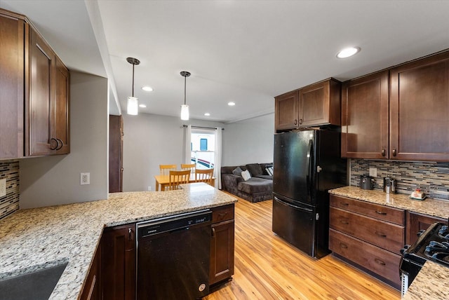 kitchen featuring a peninsula, recessed lighting, light wood-style flooring, backsplash, and black appliances