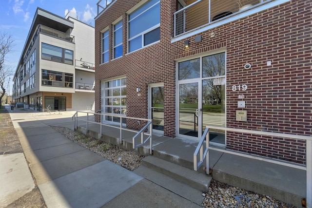 property entrance featuring brick siding
