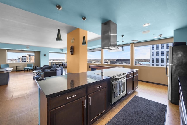 kitchen featuring dark brown cabinetry, dark stone counters, stainless steel appliances, island exhaust hood, and pendant lighting