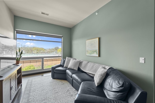 living room featuring visible vents and wood finished floors