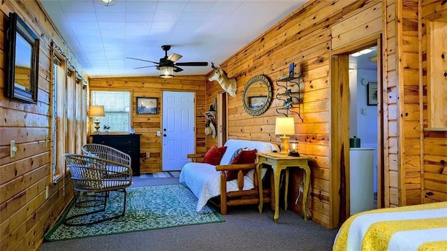 interior space with carpet and wooden walls
