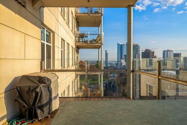 balcony with a view of city and a grill