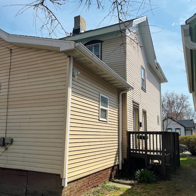1312 Center St, Racine, WI 53403 - view of side of property with a chimney and a wooden deck