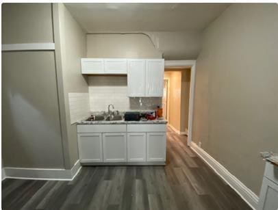 1312 Center St, Racine, WI 53403 - kitchen with a sink, baseboards, decorative backsplash, and dark wood-type flooring