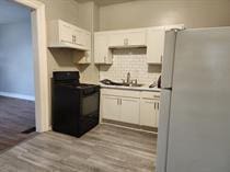 1312 Center St, Racine, WI 53403 - kitchen with white cabinets, a sink, black electric range, freestanding refrigerator, and decorative backsplash