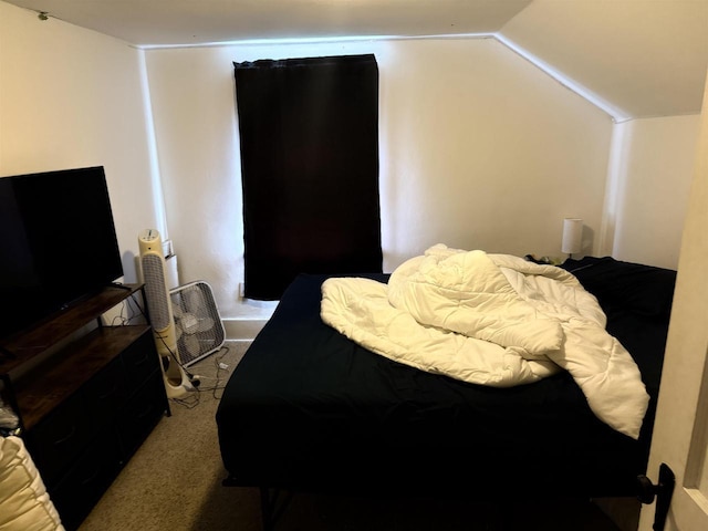 bedroom featuring carpet flooring and vaulted ceiling