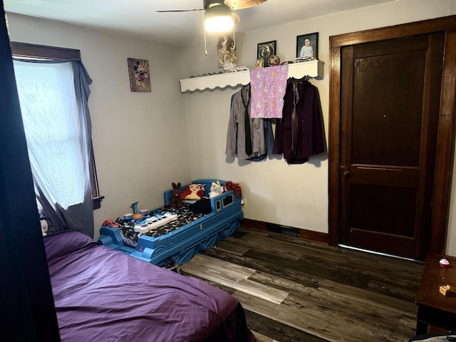 bedroom featuring baseboards, ceiling fan, and wood finished floors